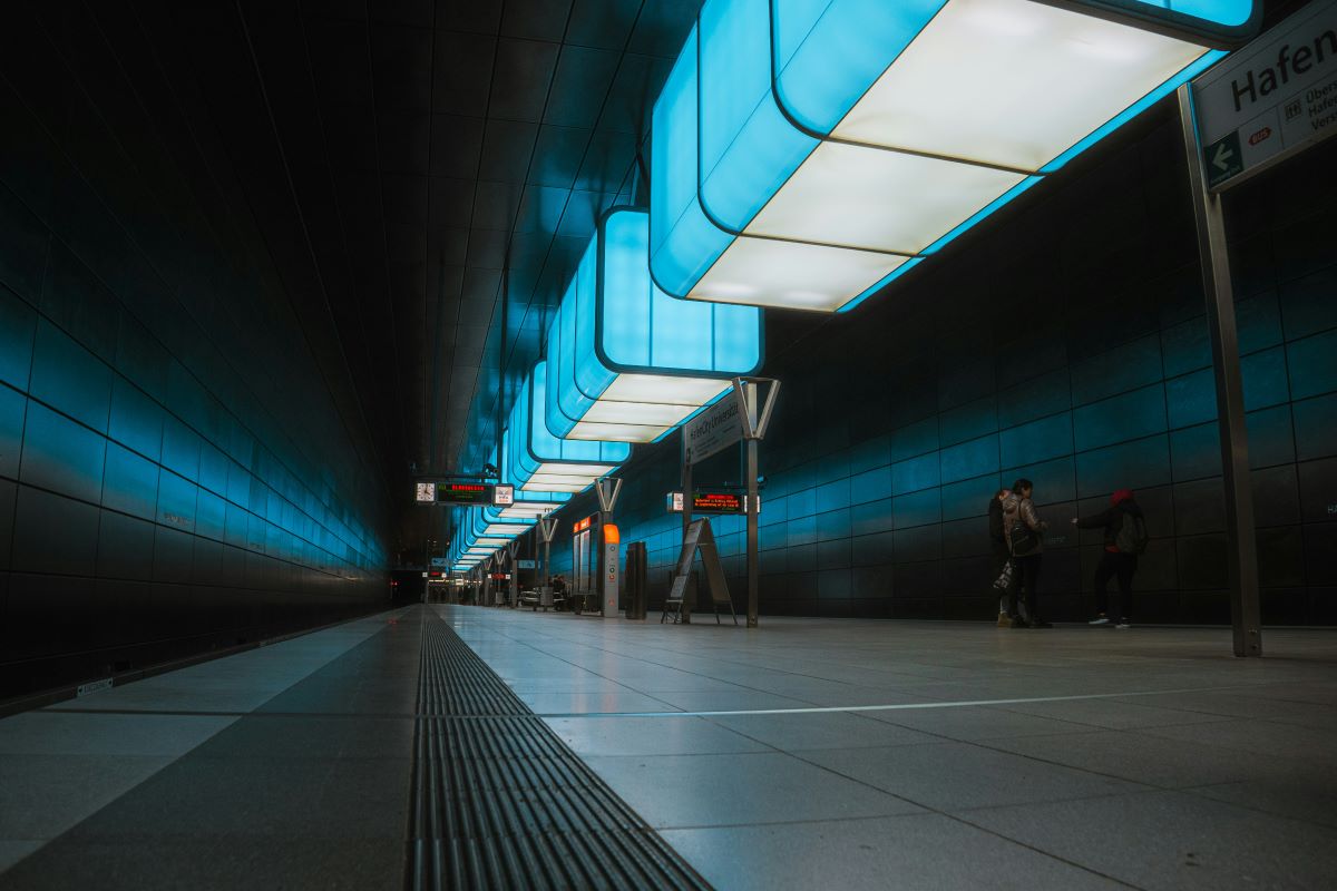 blue and white lights illuminate an underground station in Hamburg