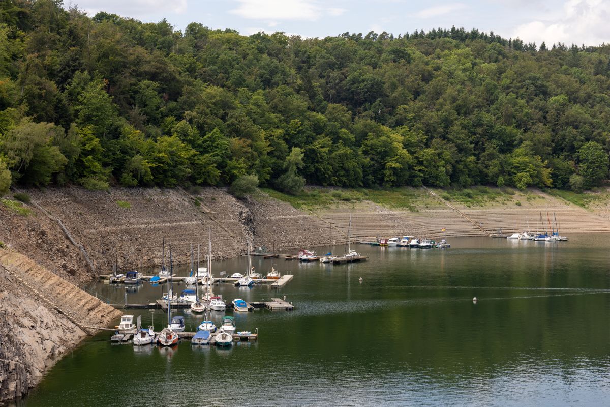 Small boats on floating docks are seen in a reservoir where the water levels have dropped extremely low.