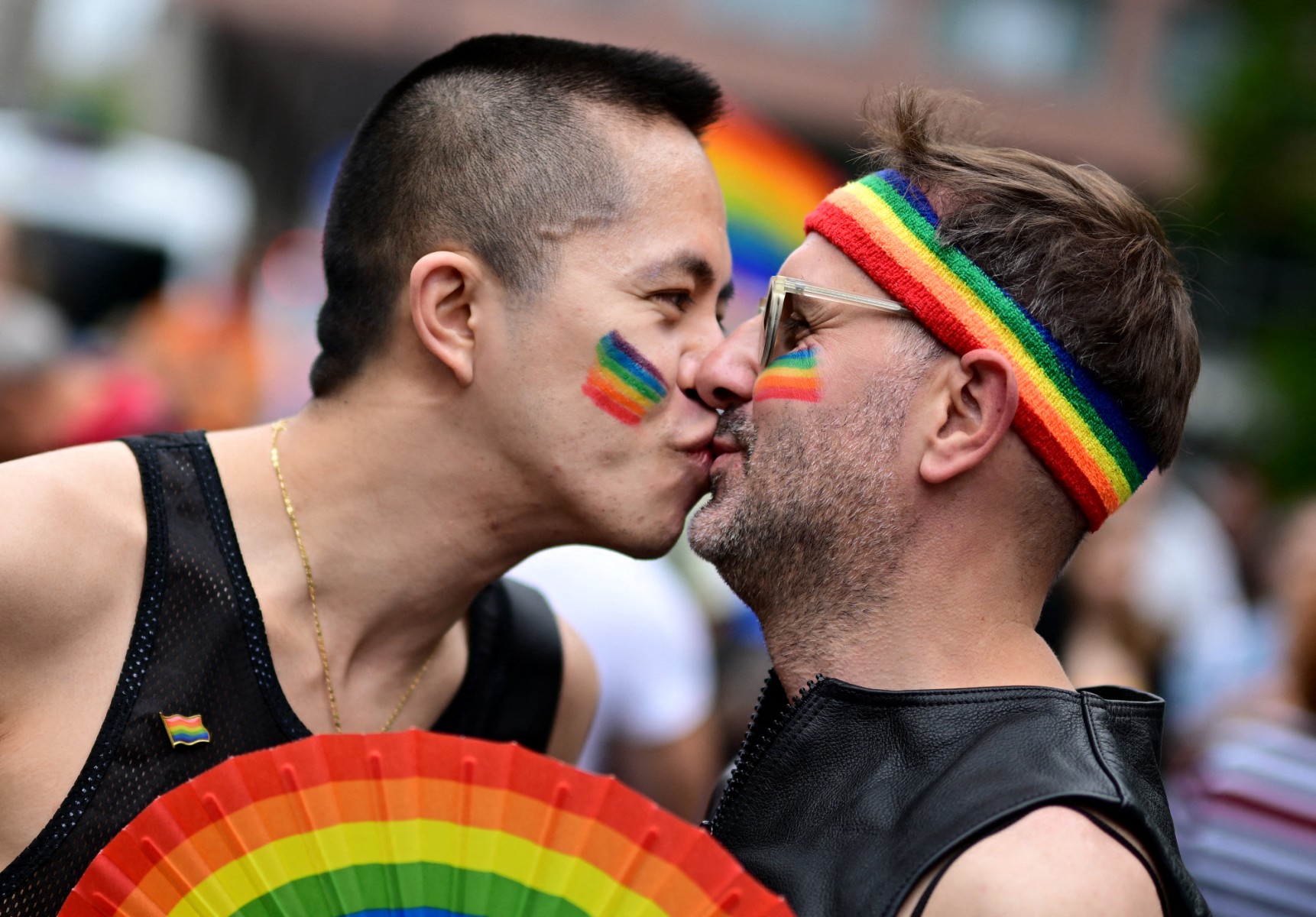 Participants of the Christopher Street Day (CSD) parade kiss as people take to the streets of Berlin on July 26, 2025 to fight for the rights of the LGBTQ+ community.