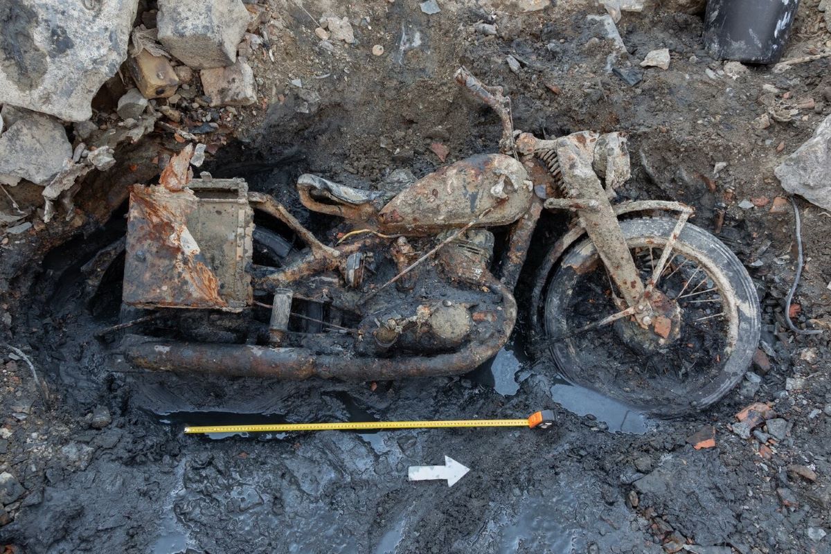 a motorbike on its side covered in mud, found near Budapest