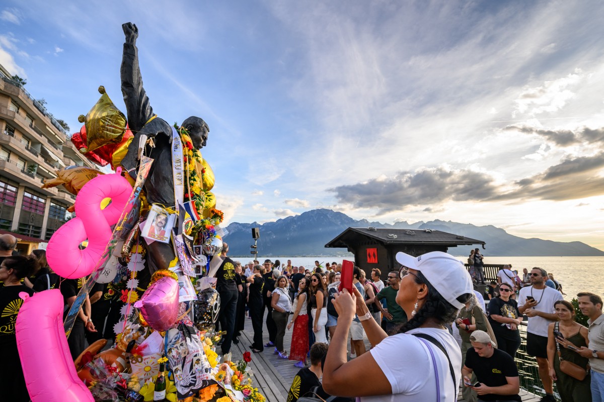 Fans gather around the iconic Freddie Mercury statue overlooking Lake Geneva during Montreux Freddie Day