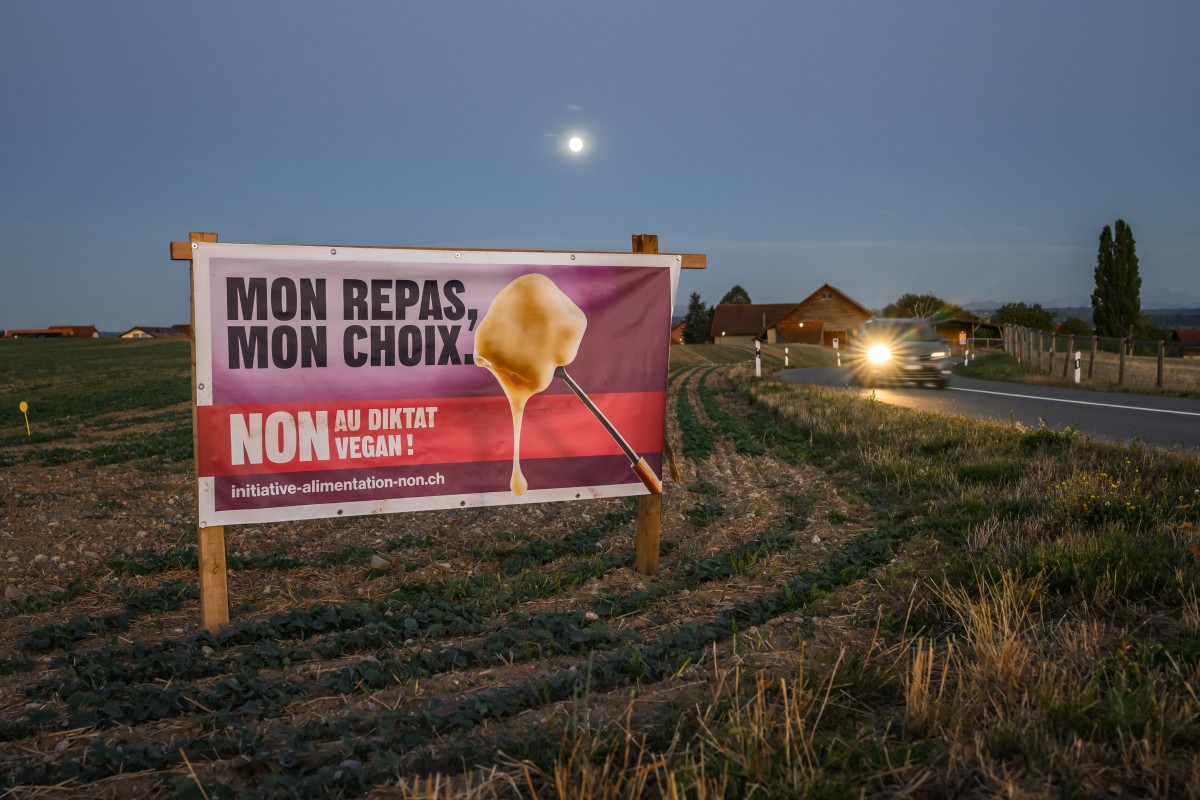 This photograph shows an campaign poster against a food security initiative reading 'My meal, my choice. No to the vegan diktat!' displayed along a road near Oulens-sous-Echallens, western Switzerland,