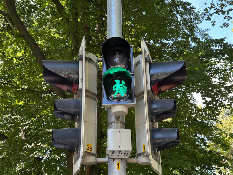 An oktoberfest drummer is seen on a green pedestrian light in Rosenheim.