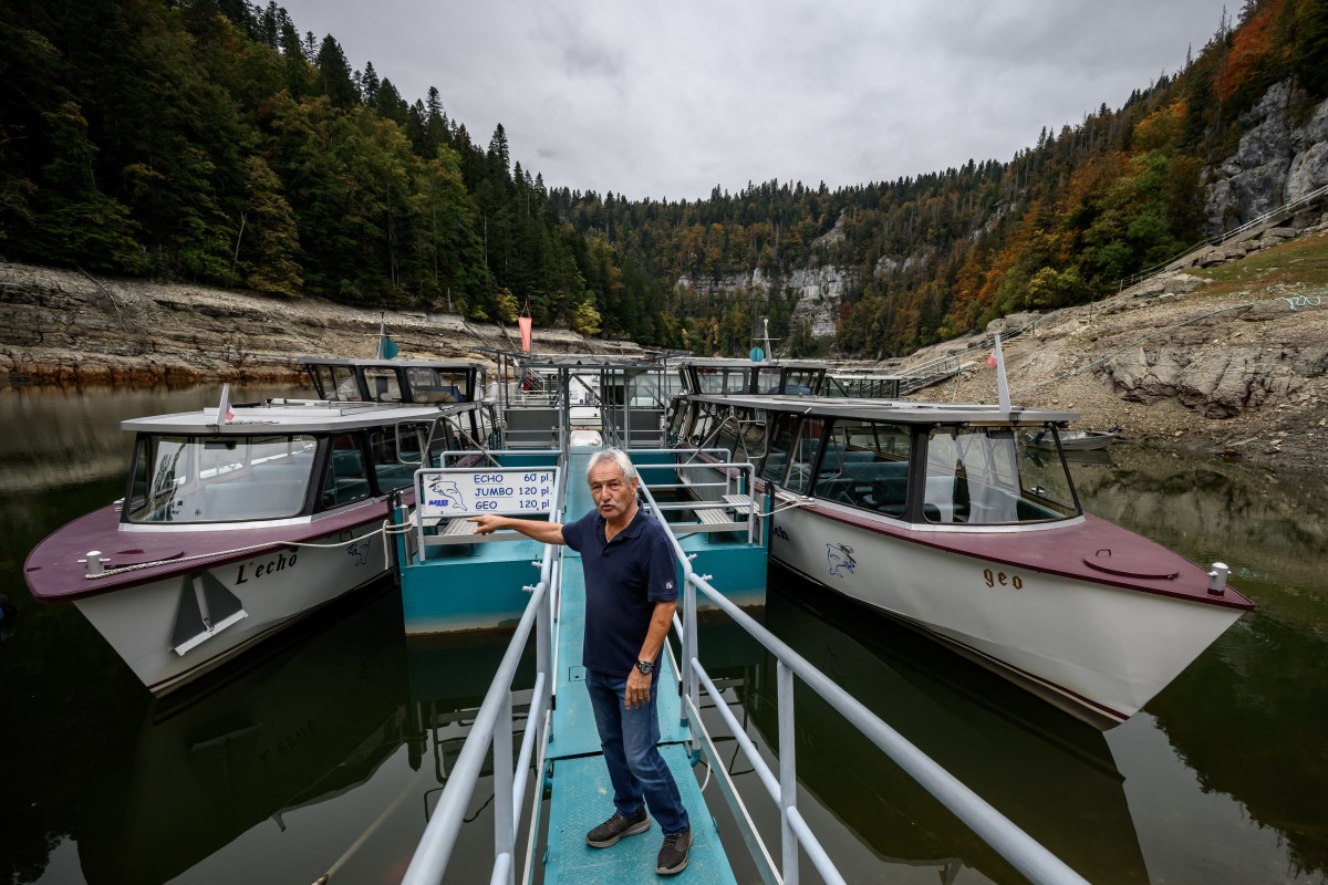 Owner and captain of the Lac des Brenets navigation company Yvan Durig gestures prior to record the water level on a daily basis at the remaining basin in the northern part of Lake Brenets (Lac des Brenets), part of the Doubs River forming a natural border between eastern France and western Switzerland, in Les Brenets