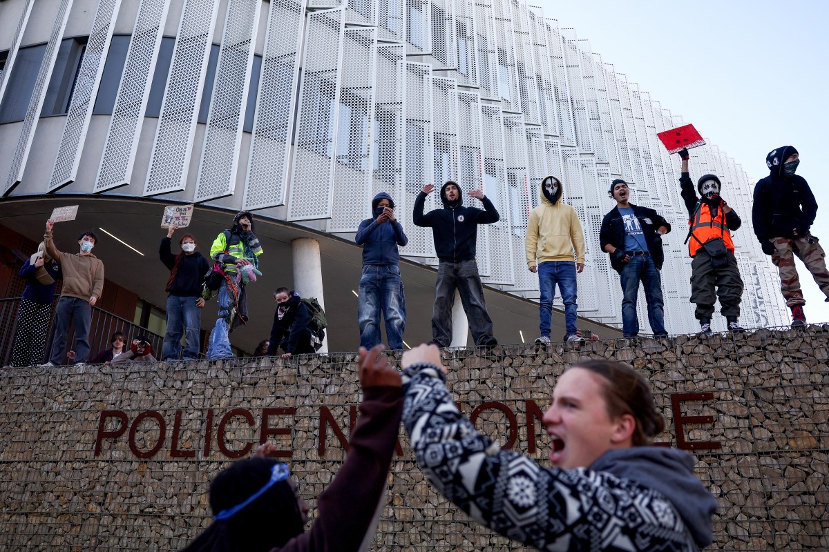 Protesters shout slogans outside the national police headquarters
