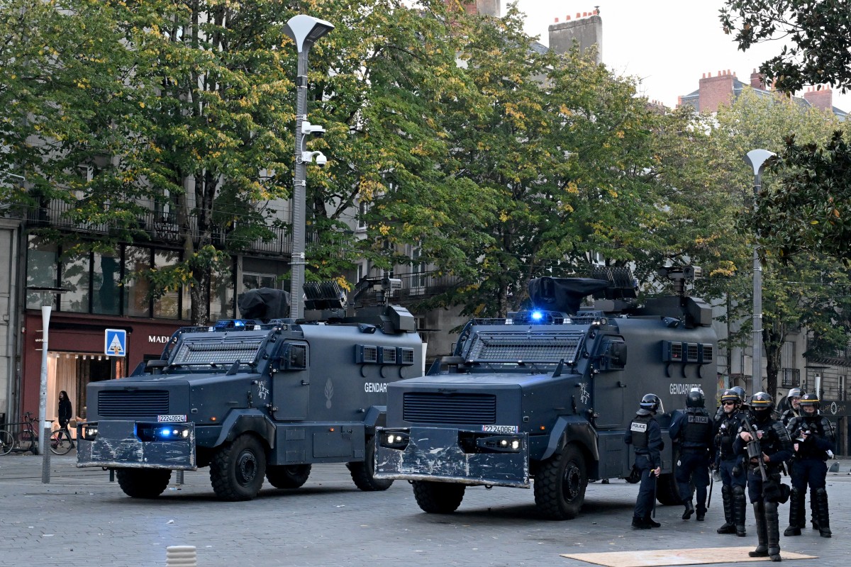 French police officers stand next to the Centaure armoured vehicles